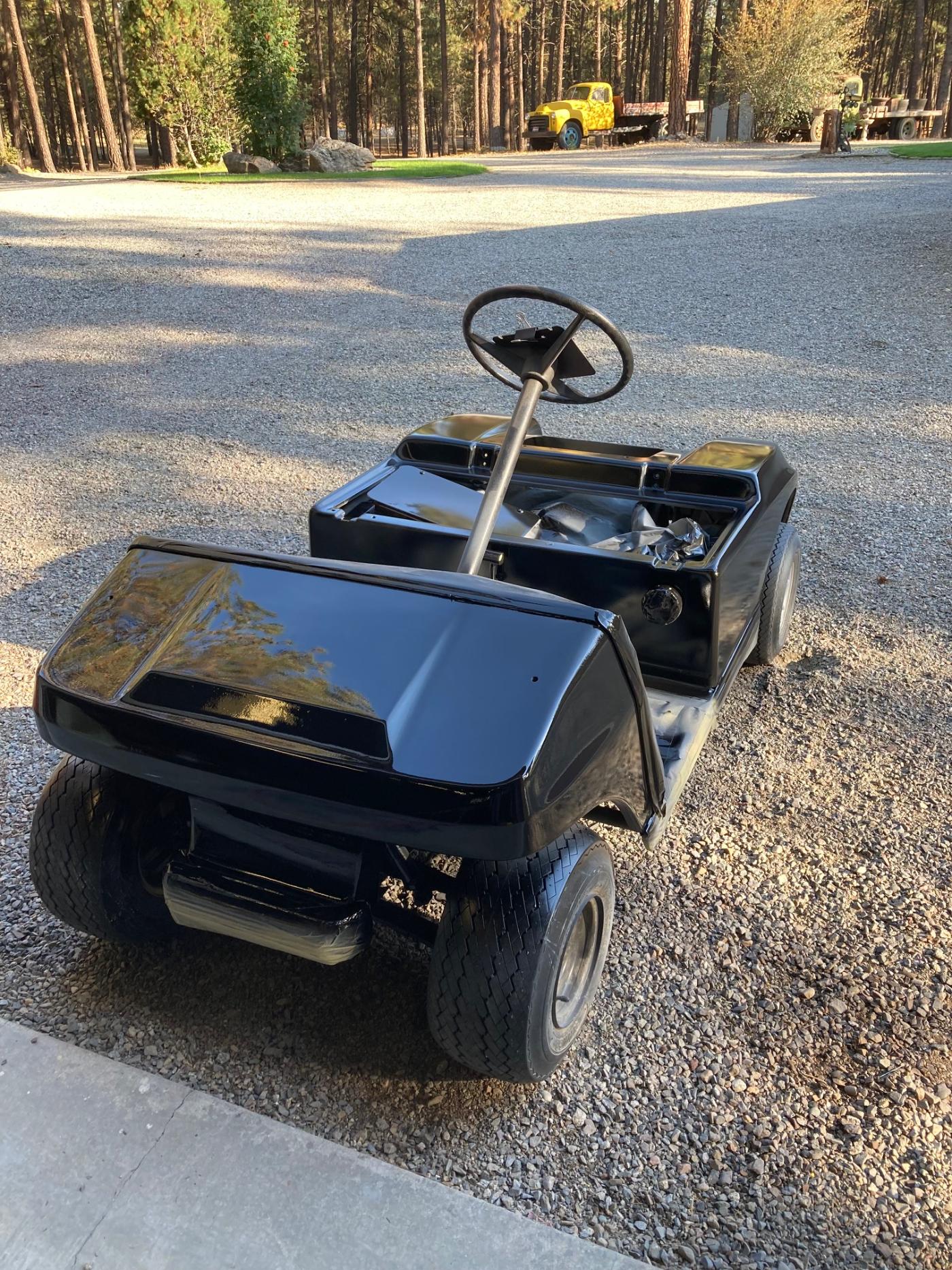 Completed golf cart rebuild — custom black body with large wheels