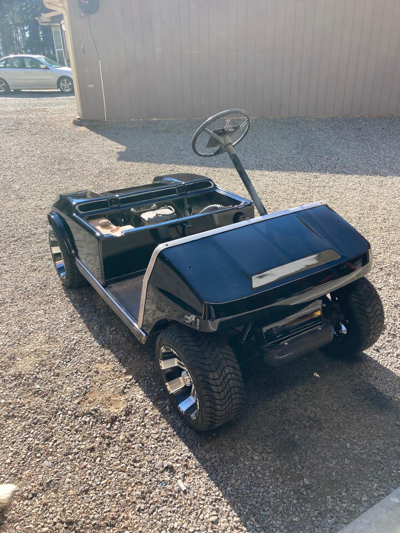 Rebuilt golf cart rear view showing custom body and wheels