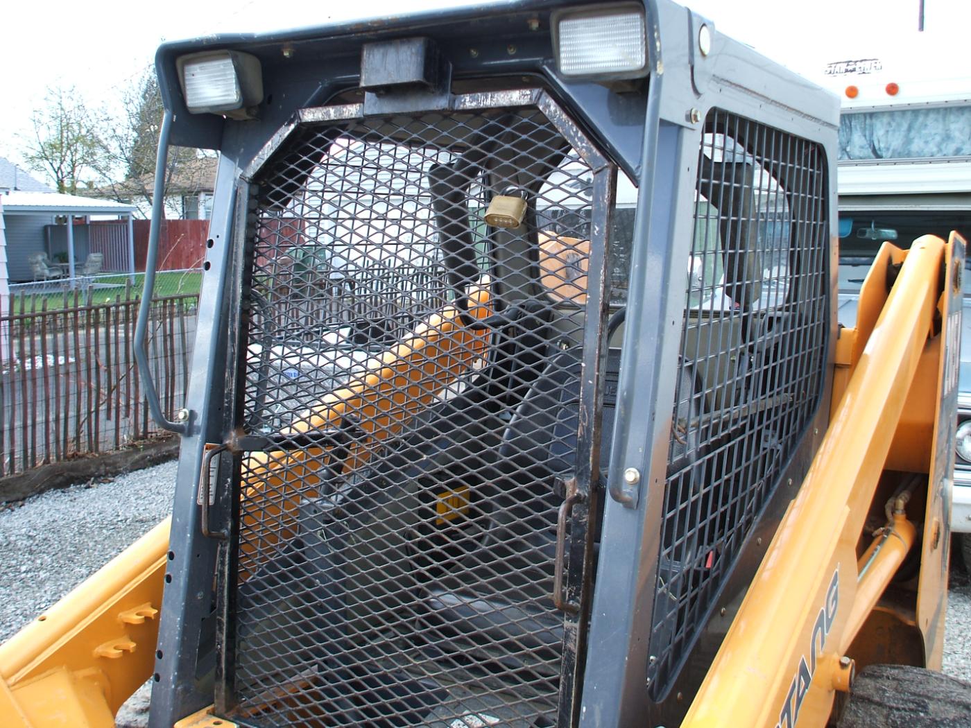 Custom fabricated operator protection cage on skid steer